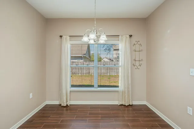 a view of a chandelier fan and wooden floor