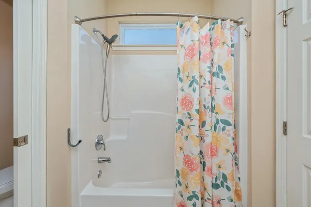 a bathroom with a shower curtain and a curtain