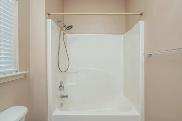 a bathroom with a shower and a bath tub
