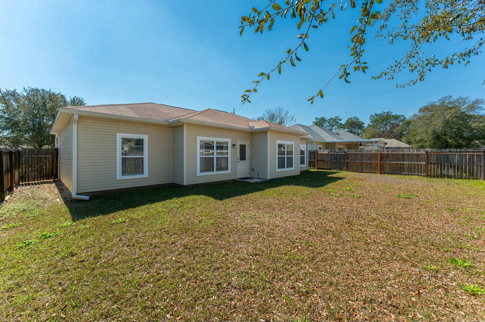 202 Ladue Avenue Crestview, FL 32539 - Photo 25 of 33 a backyard of a house with table and chairs