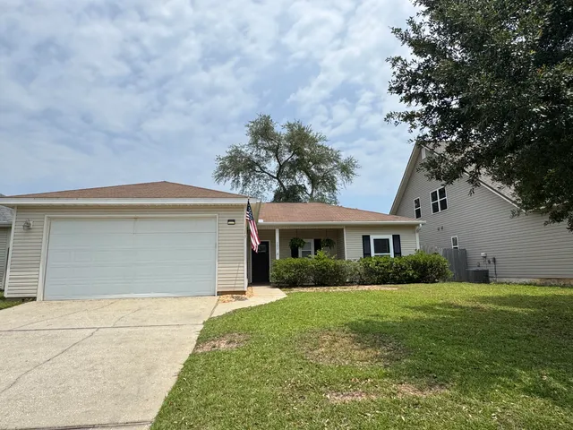 a view of house that has a yard