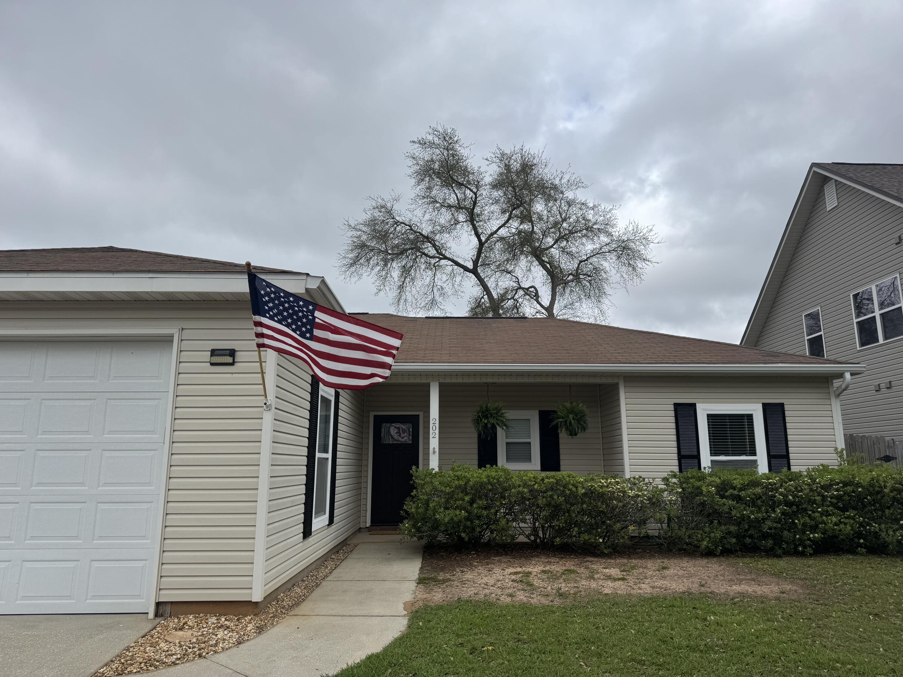 202 Ladue Avenue Crestview, FL 32539 - Photo 4 of 33 a front view of a house with a yard