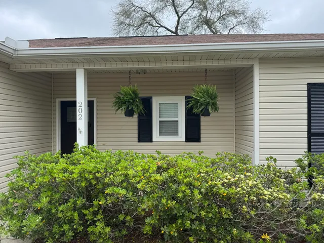 a view of a house with potted plants