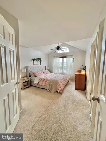 a spacious bedroom with a bed and a chandelier