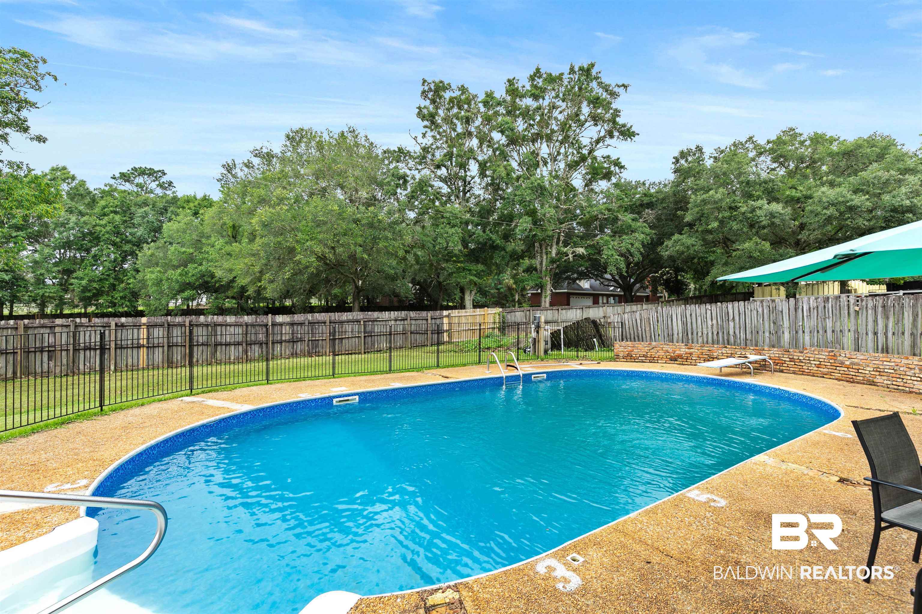 10420 Johnson Road South Mobile, AL 36695 - Photo 59 of 75 In-ground swimming pool with a textured concrete surround