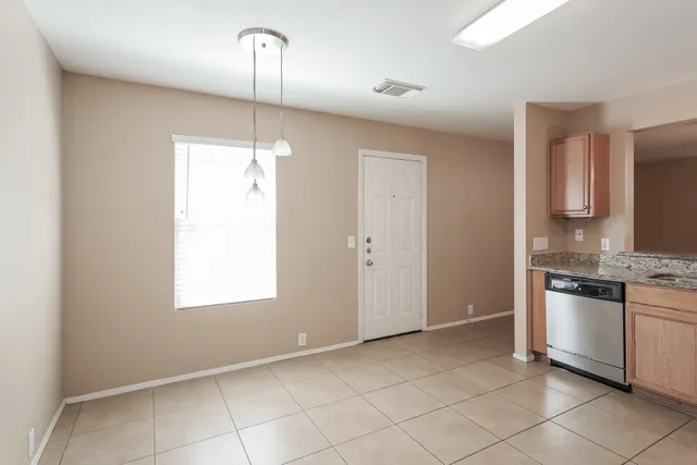 a kitchen with granite countertop a sink and a stove