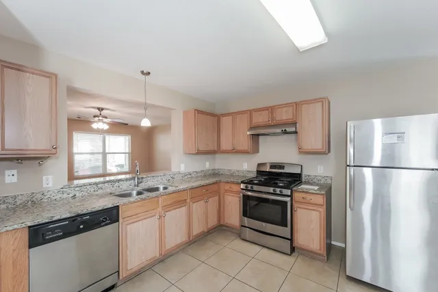 a kitchen with a sink stove and refrigerator