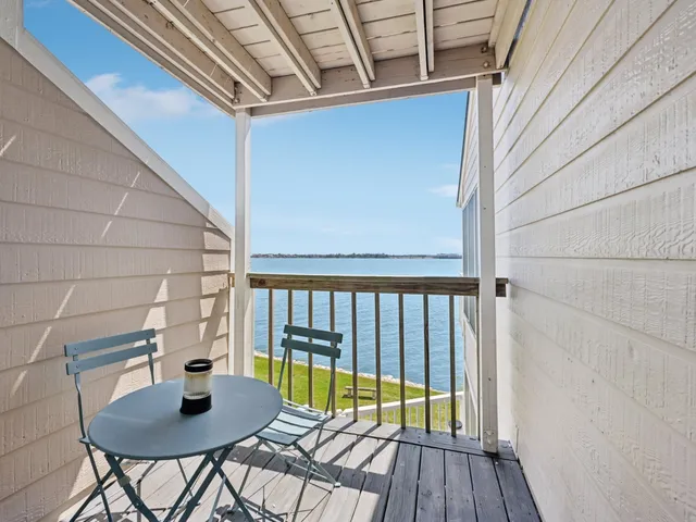 a view of balcony with wooden floor and seating space