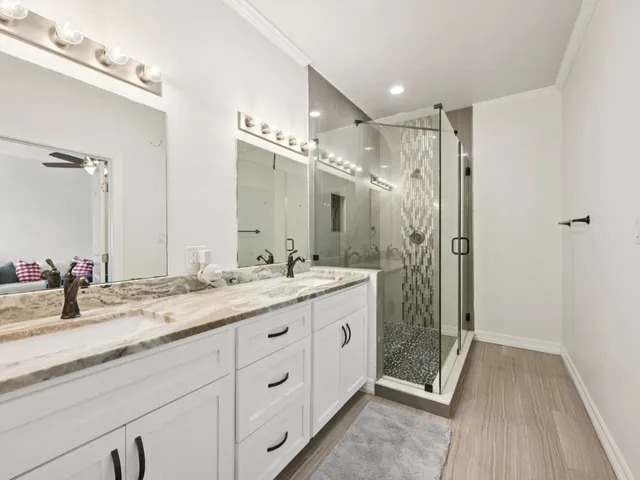 a bathroom with a granite countertop sink mirror and double
