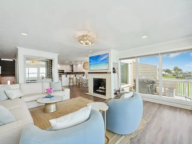 a living room with furniture fireplace and a large window