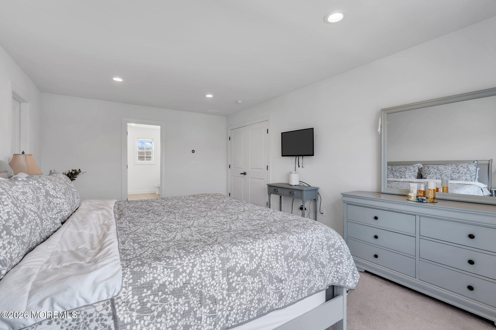 32 Tasha Lane Howell, NJ 07731 - Photo 34 of 72 a bedroom with a large bed and a flat tv screen on dresser