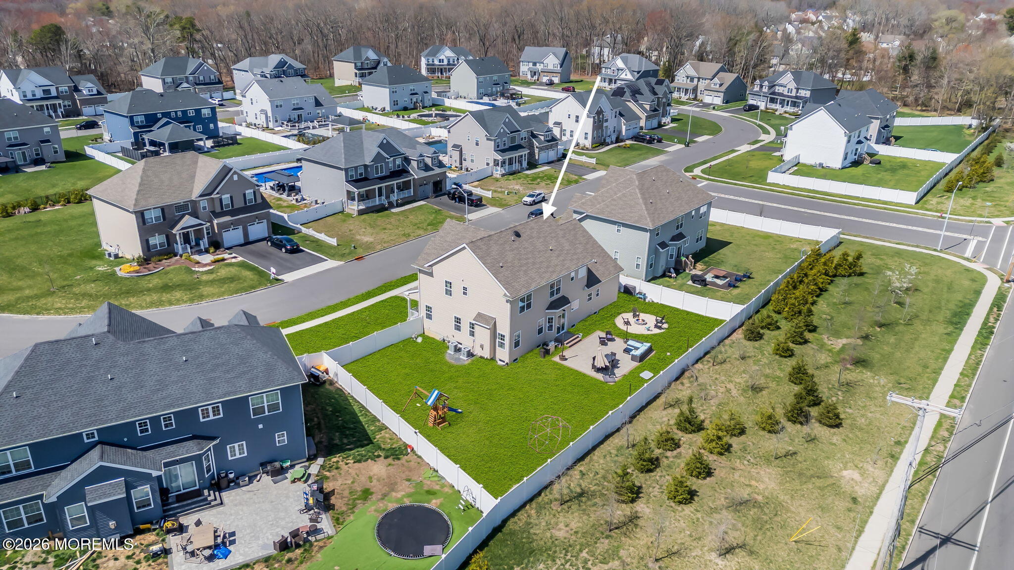 32 Tasha Lane Howell, NJ 07731 - Photo 62 of 72 an aerial view of a pool patio chairs and fire pit