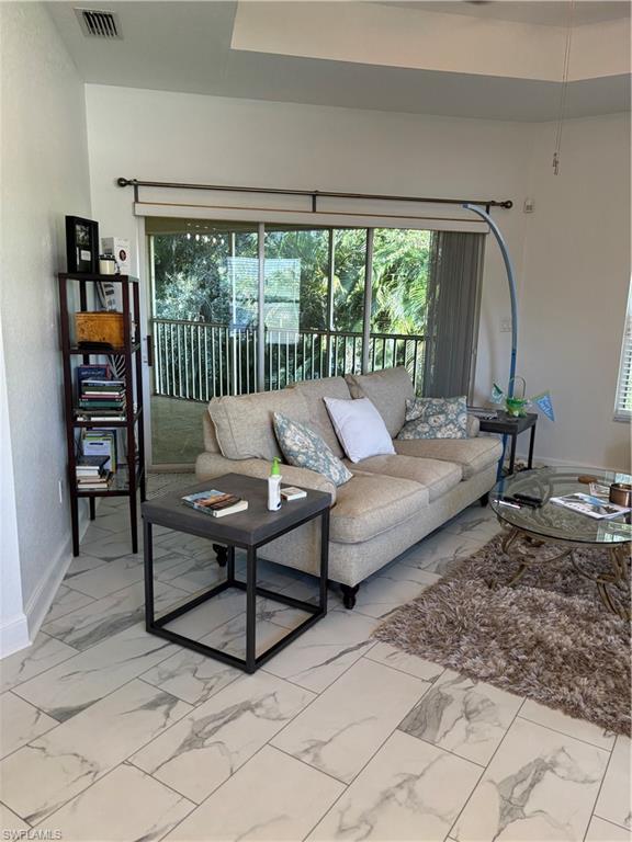 1270 Shady Rest Lane, Unit 403 Naples, FL 34103 - Photo 12 of 24 a living room with furniture and a window
