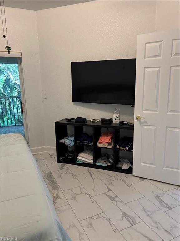1270 Shady Rest Lane, Unit 403 Naples, FL 34103 - Photo 14 of 24 a living room with furniture and a flat screen tv