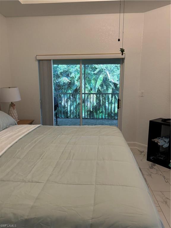 1270 Shady Rest Lane, Unit 403 Naples, FL 34103 - Photo 15 of 24 a view of a room with furniture and a flat screen tv