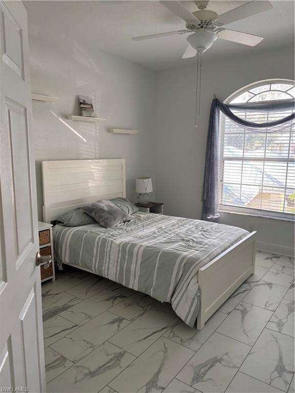 1270 Shady Rest Lane, Unit 403 Naples, FL 34103 - Photo 20 of 24 a bedroom with a bed and window