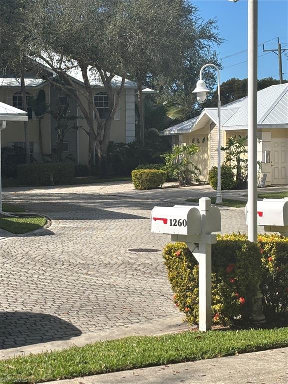 1270 Shady Rest Lane, Unit 403 Naples, FL 34103 - Photo 7 of 24 a sign board with a yard