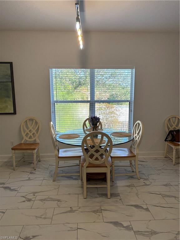 1270 Shady Rest Lane, Unit 403 Naples, FL 34103 - Photo 9 of 24 a living room with furniture and a window