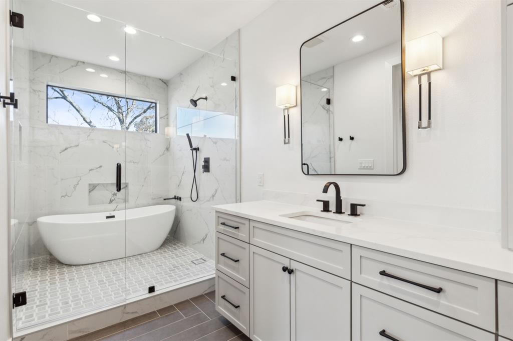 4311 Merrell Road Dallas, TX 75229 - Photo 19 of 30 a bathroom with a double vanity sink mirror and bathtub