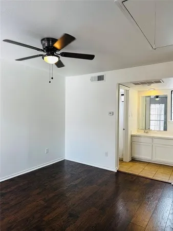 a view of room with wooden floor and fan