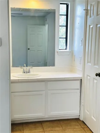 a bathroom with a sink a vanity and a bathtub
