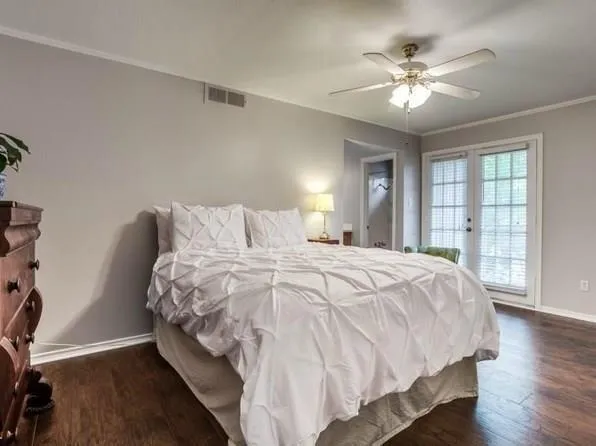 a bedroom with a large bed and a chandelier