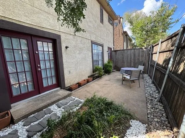 a backyard of a house with outdoor seating