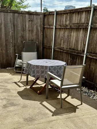 a view of a chairs and table in the back yard