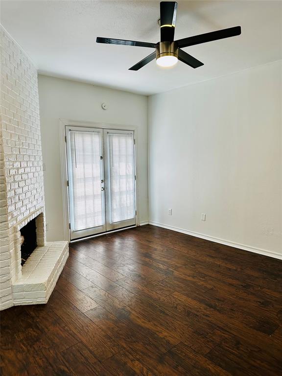 4000 Rawlins Street, Unit 101B Dallas, TX 75219 - Photo 6 of 27 an empty room with wooden floor fireplace and windows