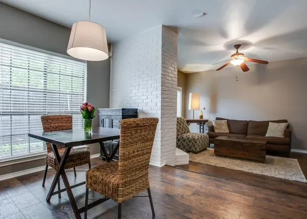 a living room with furniture a chandelier and a window
