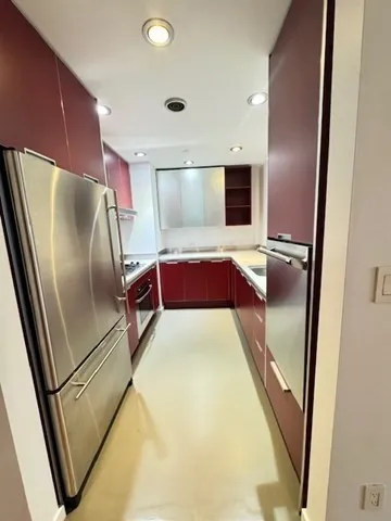 a kitchen with refrigerator and mirror