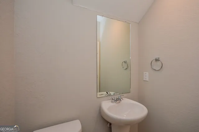 a bathroom with a sink a toilet