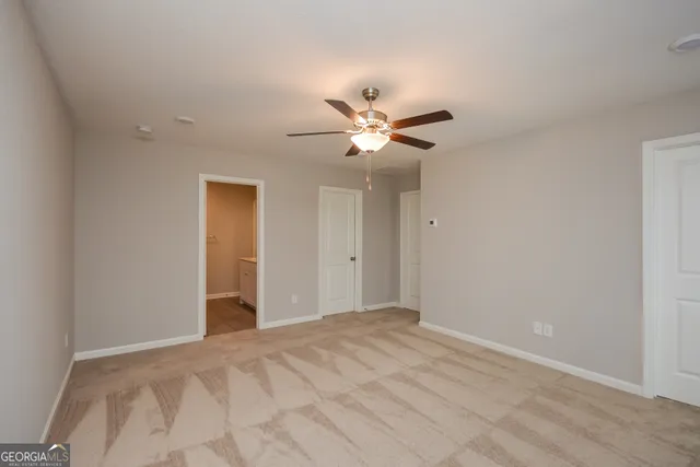 a view of a room with a ceiling fan