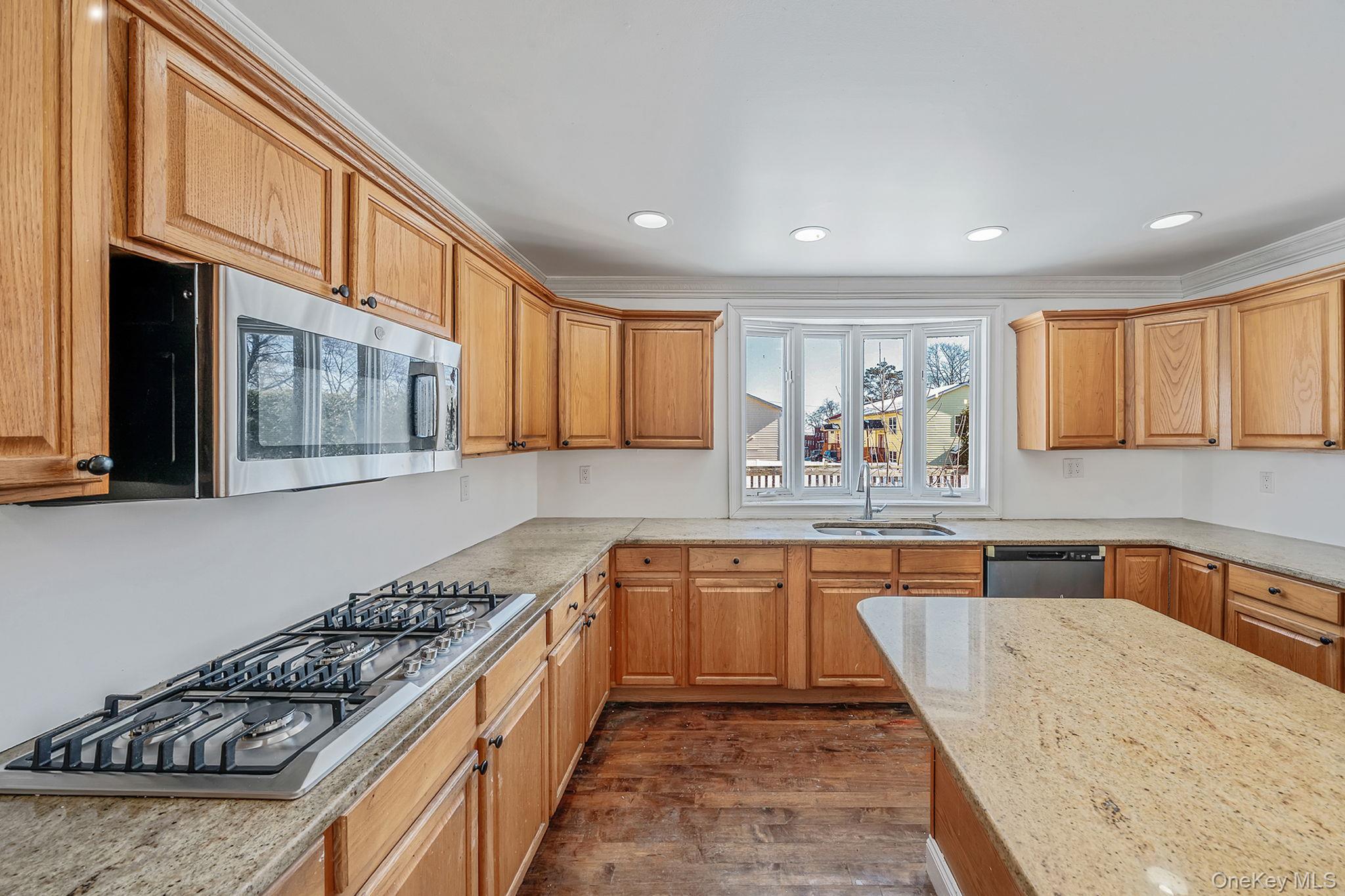 128 Bethune Boulevard Spring Valley, NY 10977 - Photo 11 of 34 a large kitchen with stainless steel appliances granite countertop a stove and a sink
