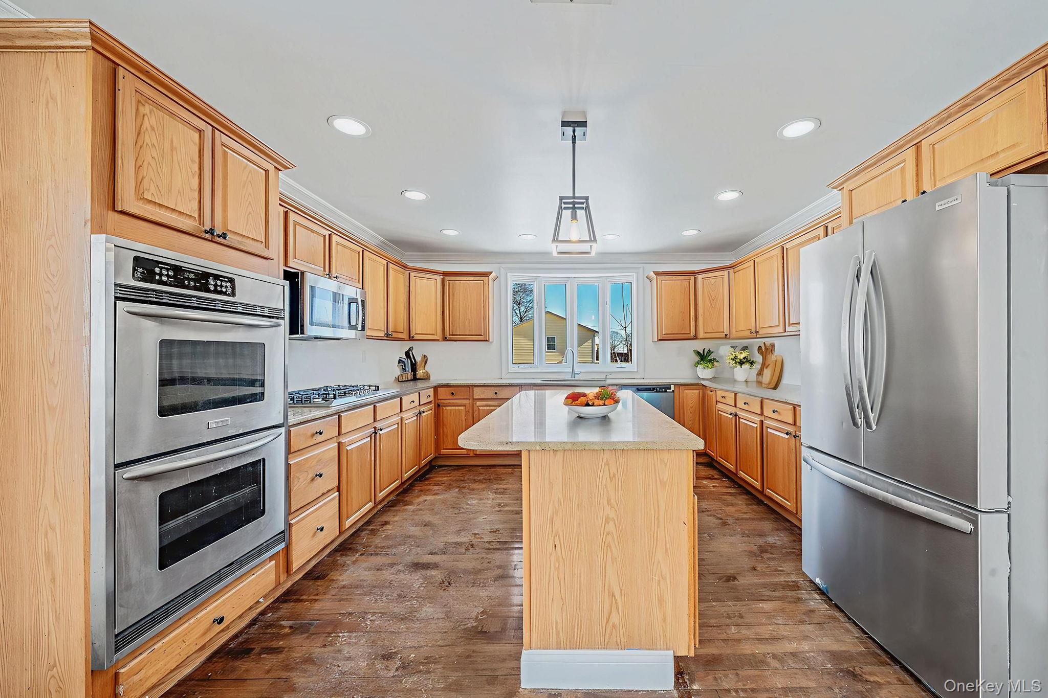 128 Bethune Boulevard Spring Valley, NY 10977 - Photo 12 of 34 a kitchen with stainless steel appliances kitchen island granite countertop a refrigerator a stove and a sink with cabinets