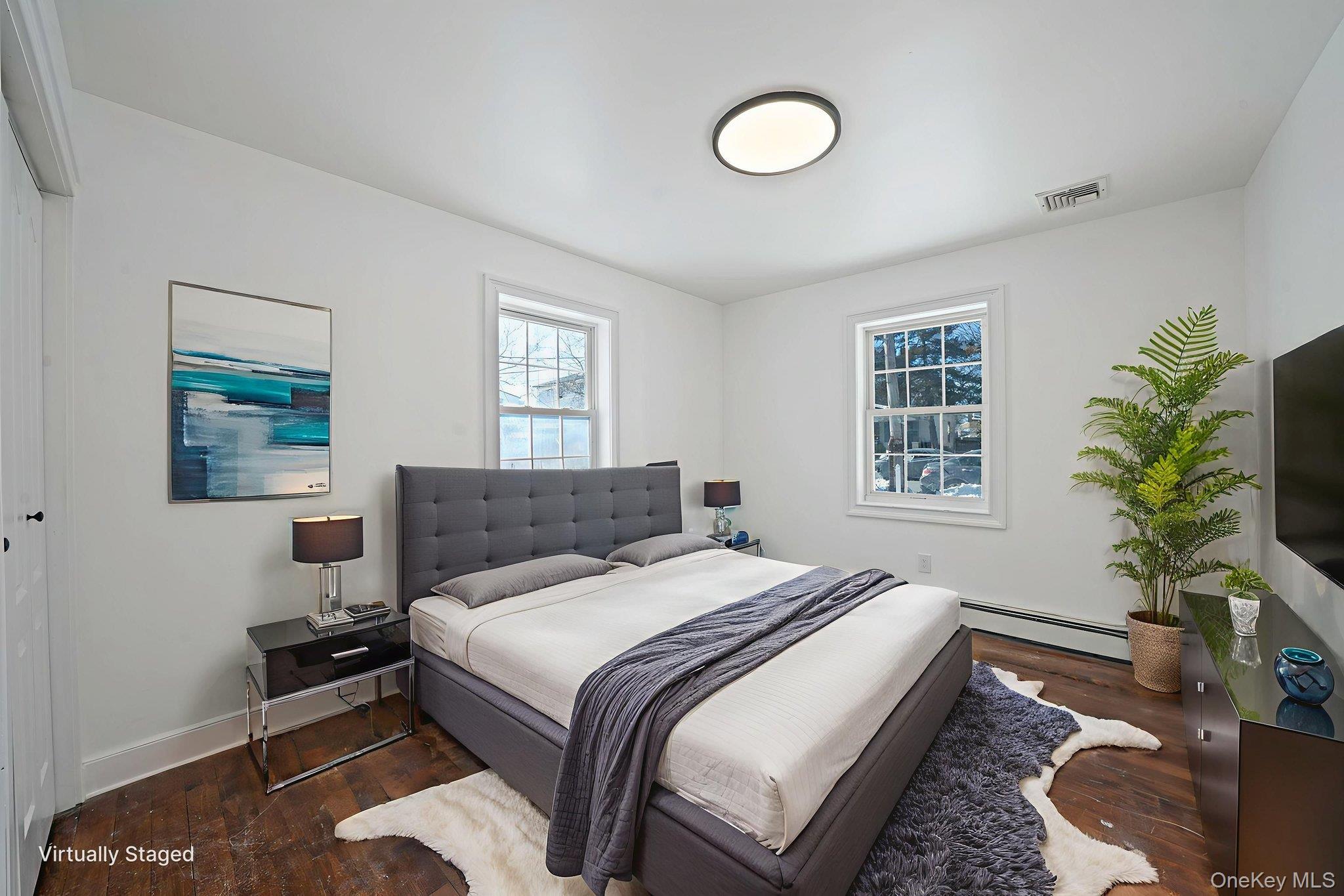 128 Bethune Boulevard Spring Valley, NY 10977 - Photo 14 of 34 a bedroom with a bed lamp and a potted plant