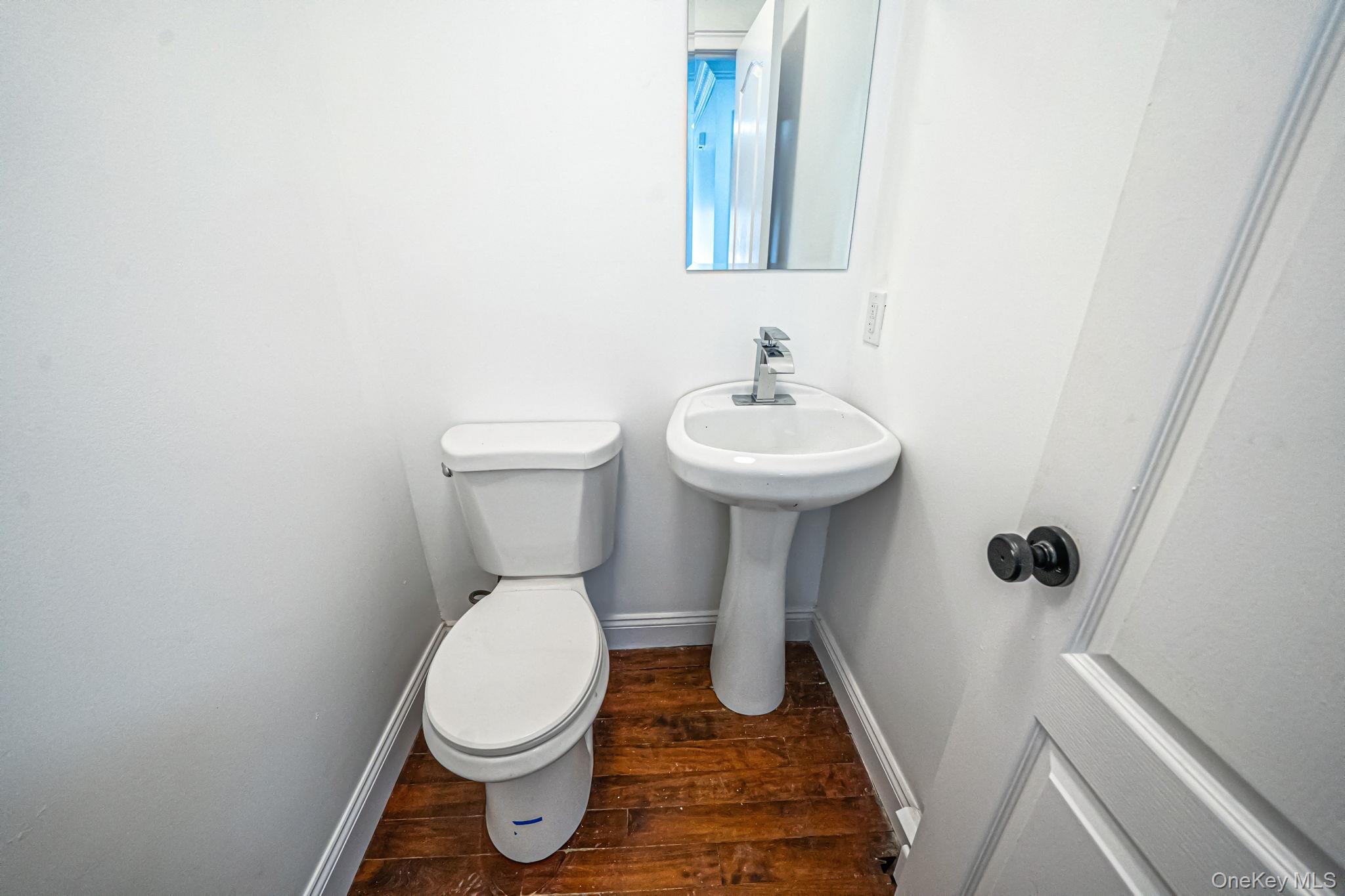 128 Bethune Boulevard Spring Valley, NY 10977 - Photo 19 of 34 a bathroom with a toilet sink and mirror