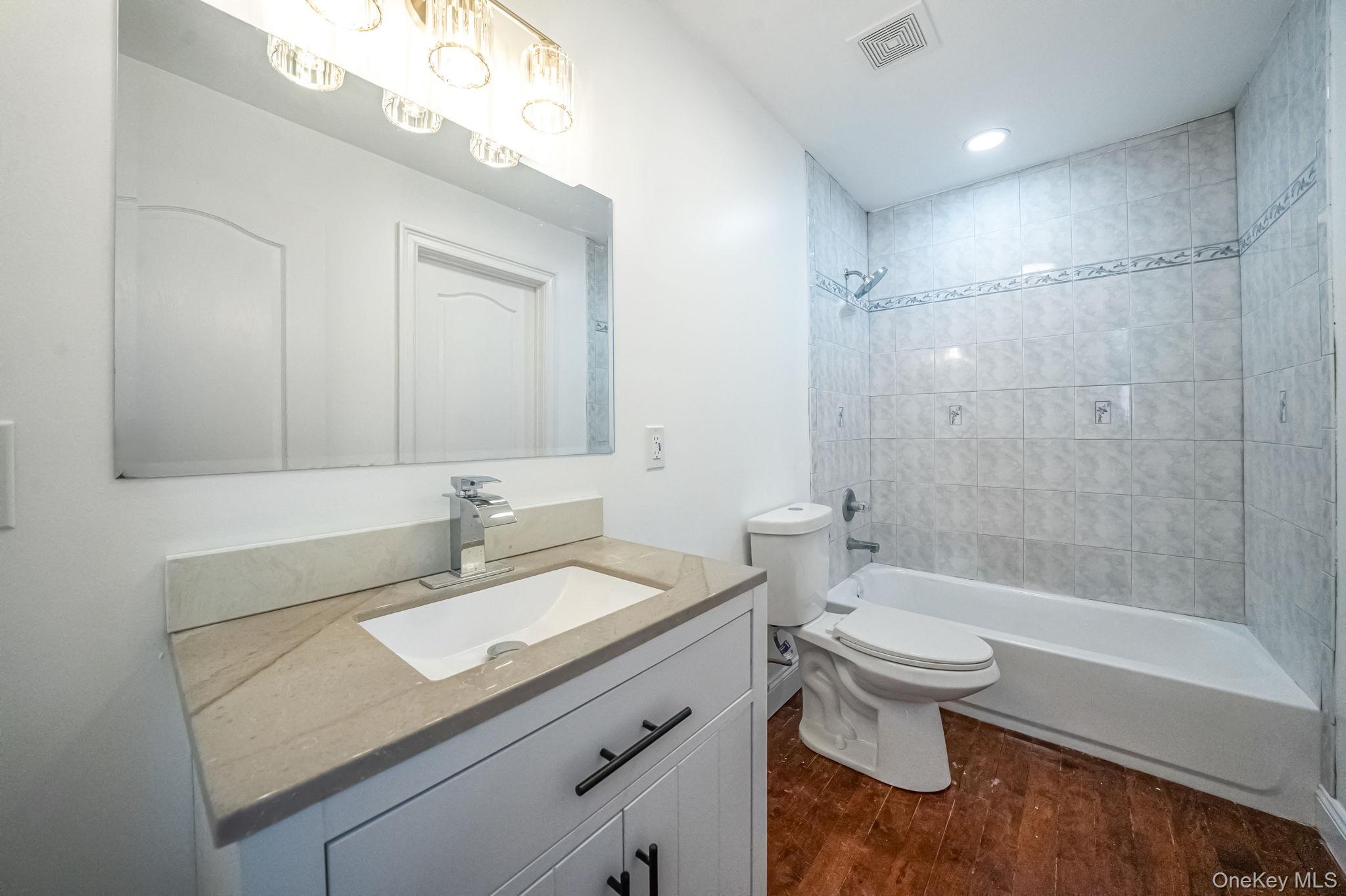 128 Bethune Boulevard Spring Valley, NY 10977 - Photo 20 of 34 a bathroom with a sink a toilet and shower