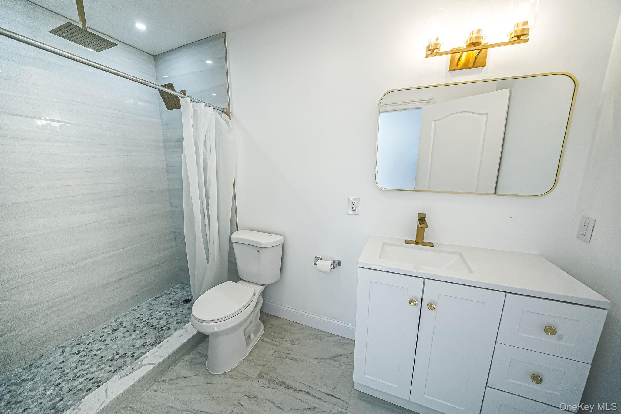 128 Bethune Boulevard Spring Valley, NY 10977 - Photo 21 of 34 a bathroom with a toilet sink and mirror