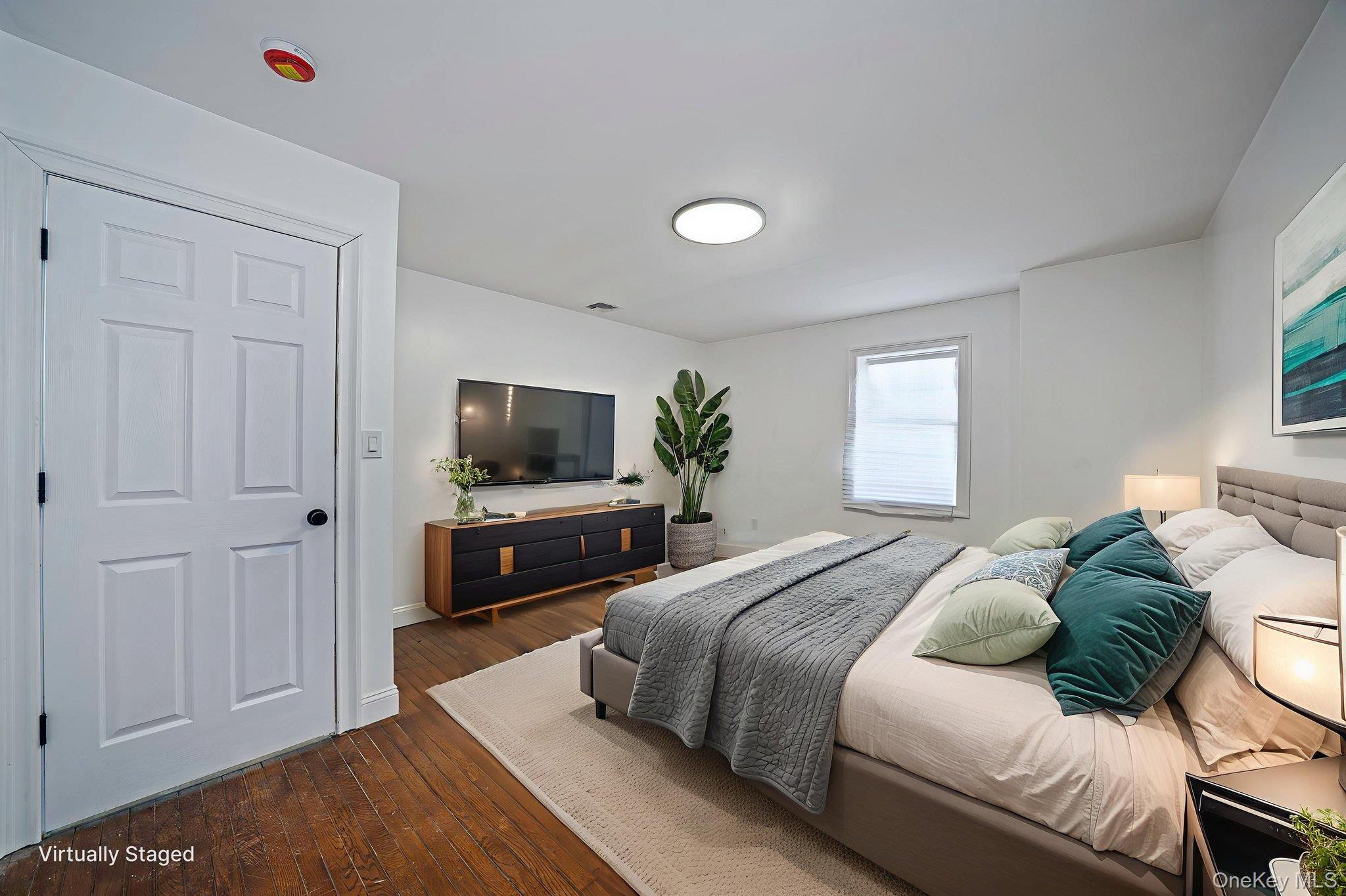 128 Bethune Boulevard Spring Valley, NY 10977 - Photo 27 of 34 a bedroom with a bed and a flat screen tv