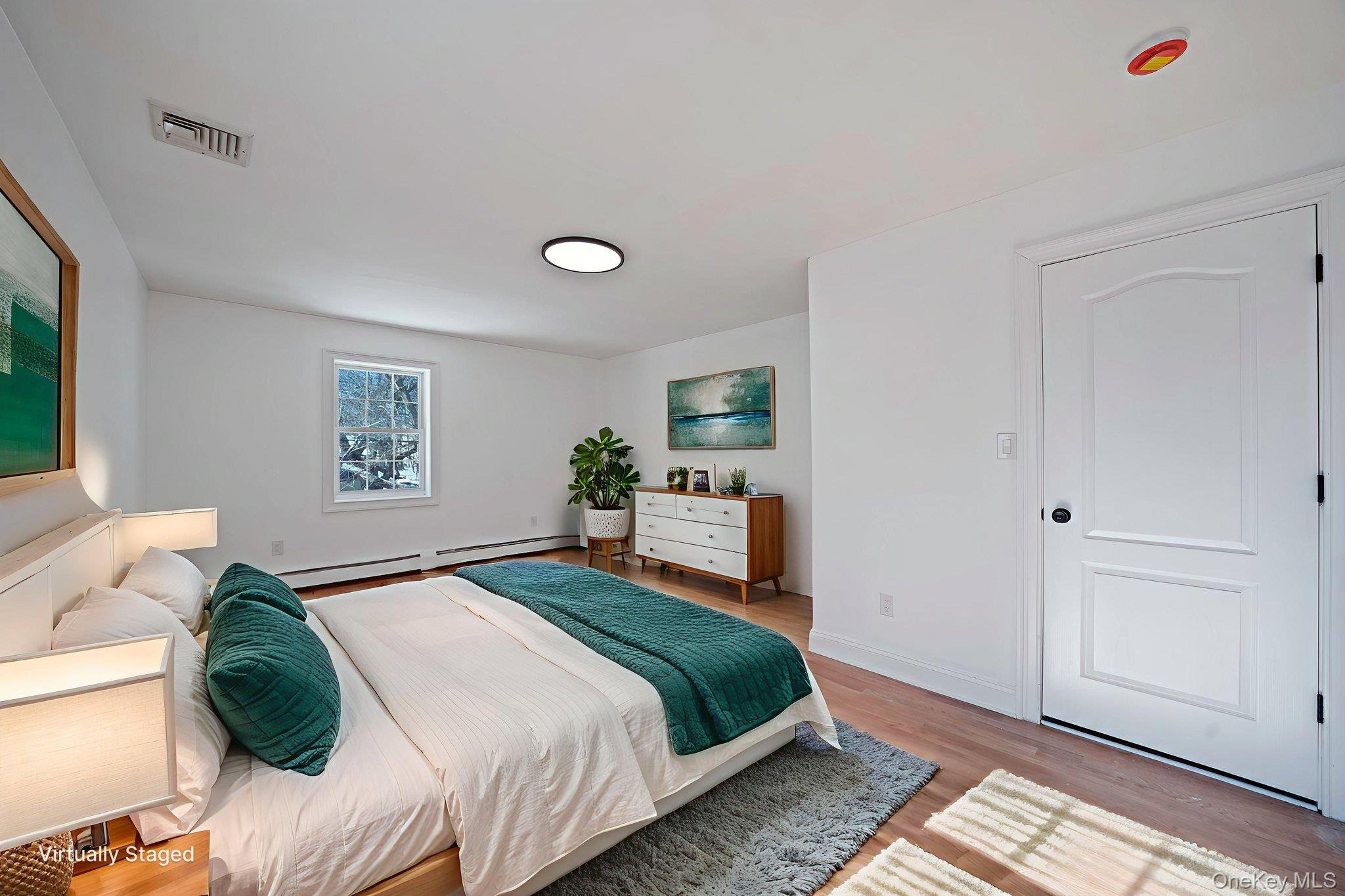128 Bethune Boulevard Spring Valley, NY 10977 - Photo 29 of 34 a bedroom with a bed and wooden floor