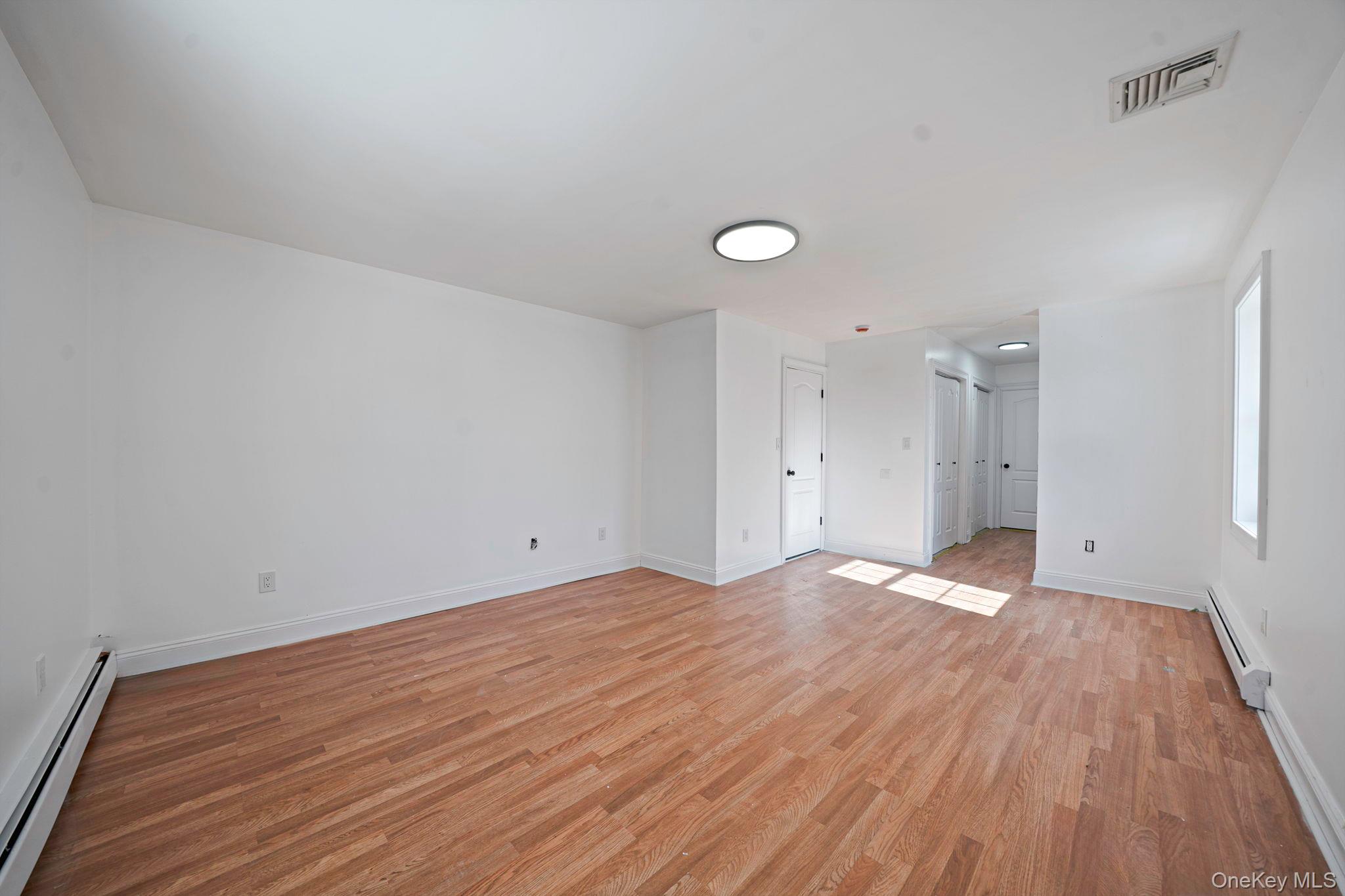 128 Bethune Boulevard Spring Valley, NY 10977 - Photo 30 of 34 a view of empty room with wooden floor and fan