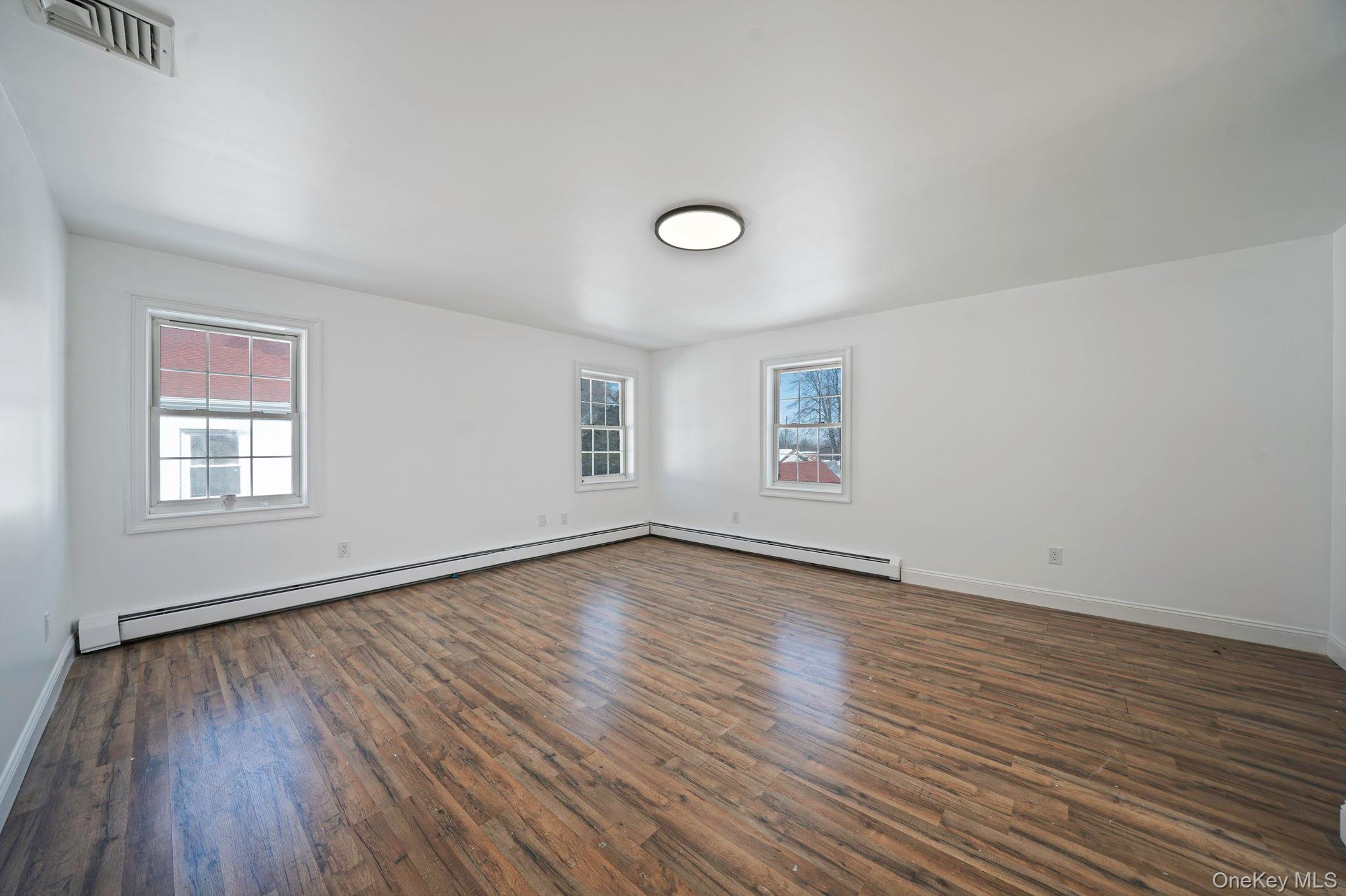 128 Bethune Boulevard Spring Valley, NY 10977 - Photo 31 of 34 an empty room with wooden floor and windows