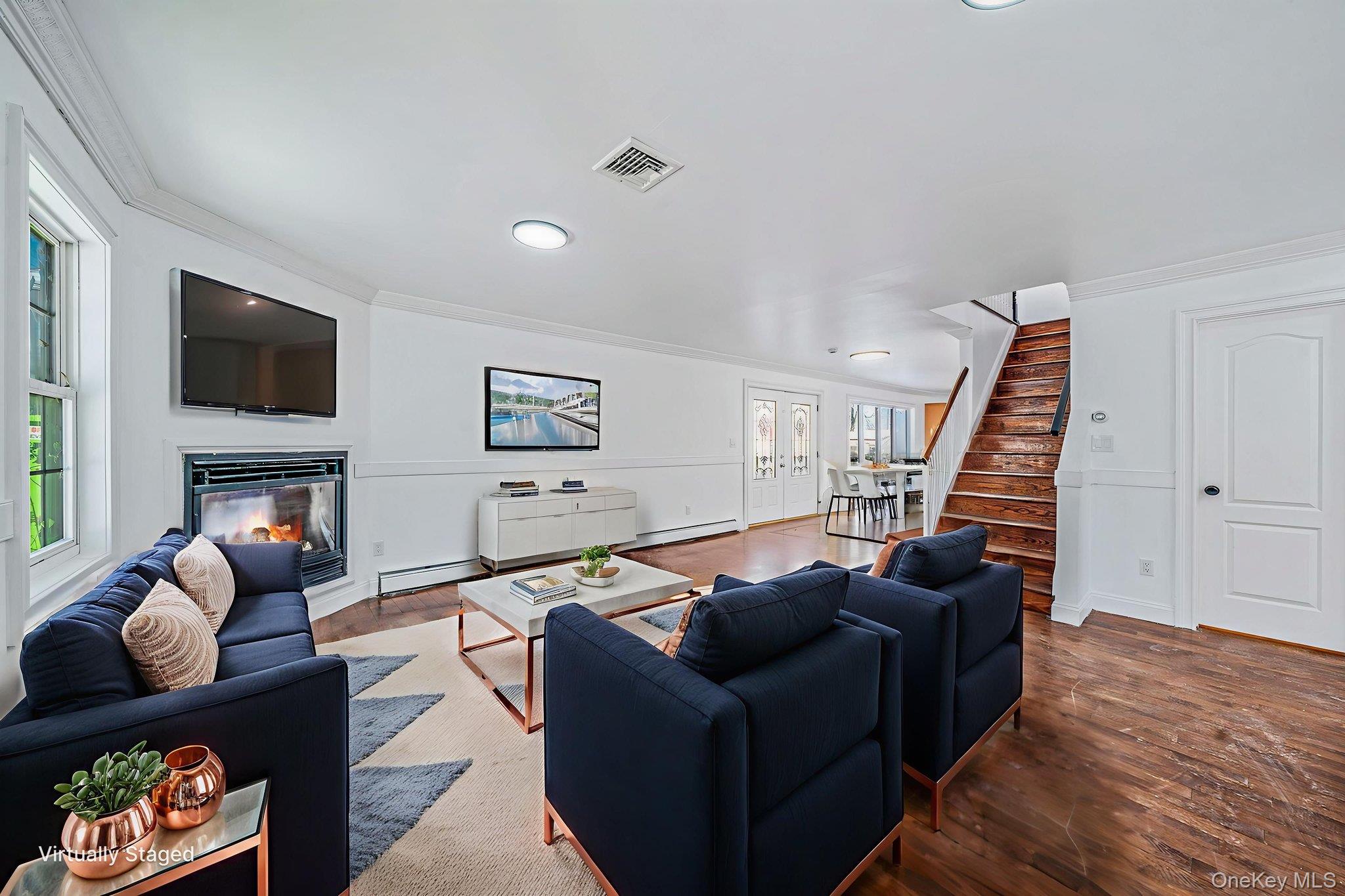 128 Bethune Boulevard Spring Valley, NY 10977 - Photo 5 of 34 a living room with furniture a flat screen tv and a fireplace