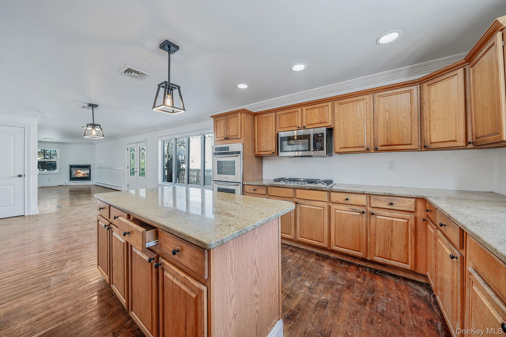 128 Bethune Boulevard Spring Valley, NY 10977 - Photo 10 of 34 a kitchen with stainless steel appliances granite countertop a sink stove and cabinets