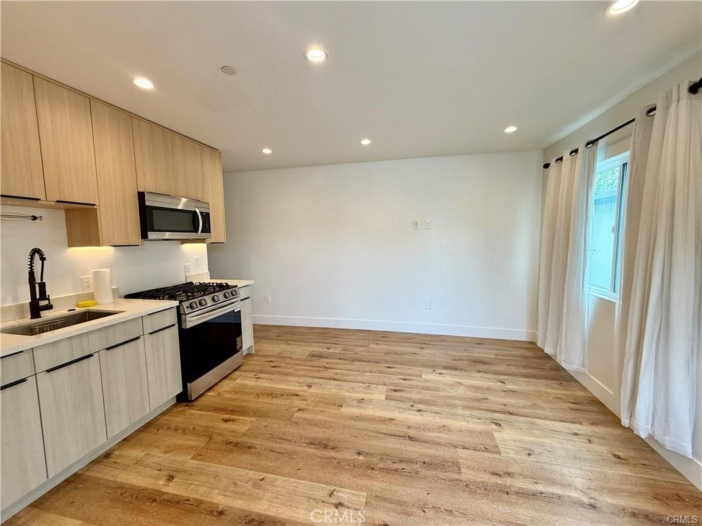 6902 Corbin Avenue Reseda, CA 91335 - Photo 2 of 10 a large kitchen with stainless steel appliances granite countertop a stove a sink and a refrigerator
