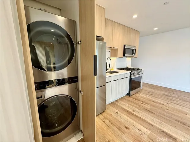 a view of a kitchen with a washer and dryer