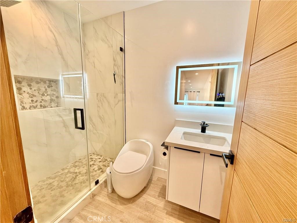 6902 Corbin Avenue Reseda, CA 91335 - Photo 4 of 10 a bathroom with a granite countertop sink toilet and shower