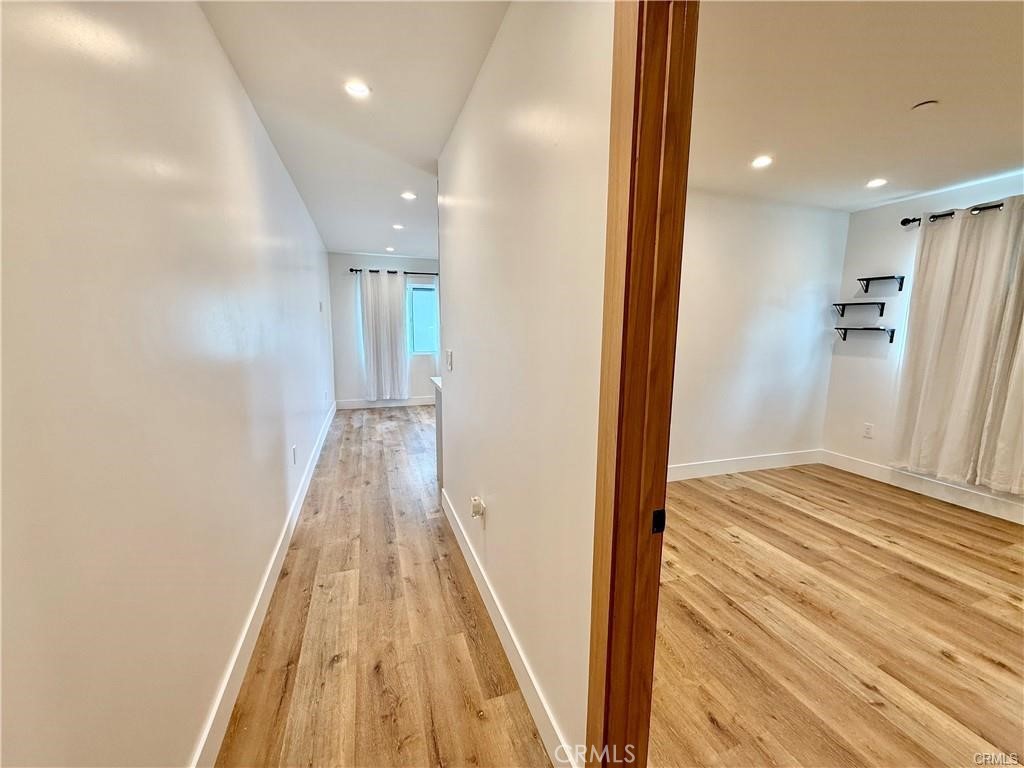 6902 Corbin Avenue Reseda, CA 91335 - Photo 6 of 10 a view of a hallway with wooden floor and staircase