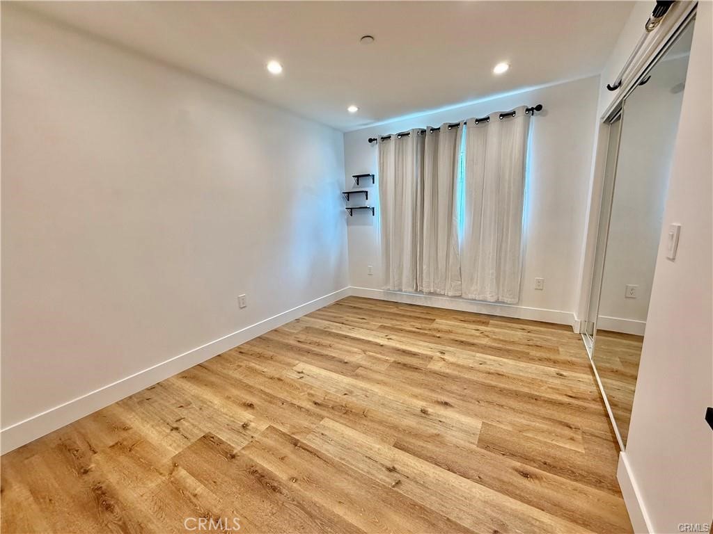 6902 Corbin Avenue Reseda, CA 91335 - Photo 7 of 10 a view of a room with wooden floor and white walls